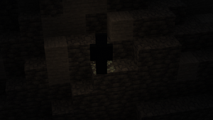 Shadow-like humanoid standing above Glow Lichen in a poorly-lit cave system.
